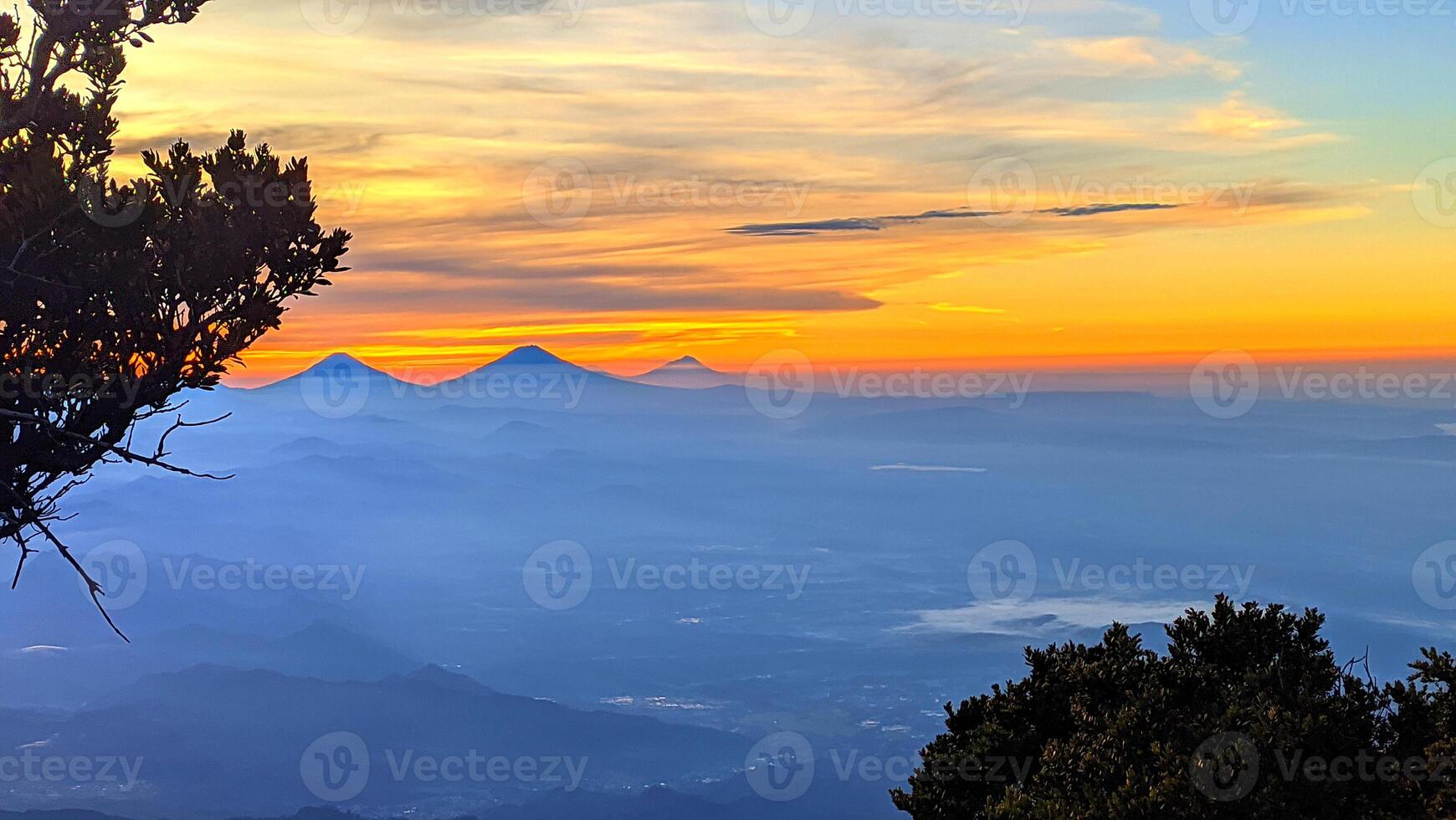 morning sunrise light at the top of Mount Slamet with a background of colorful sky light patterns photo