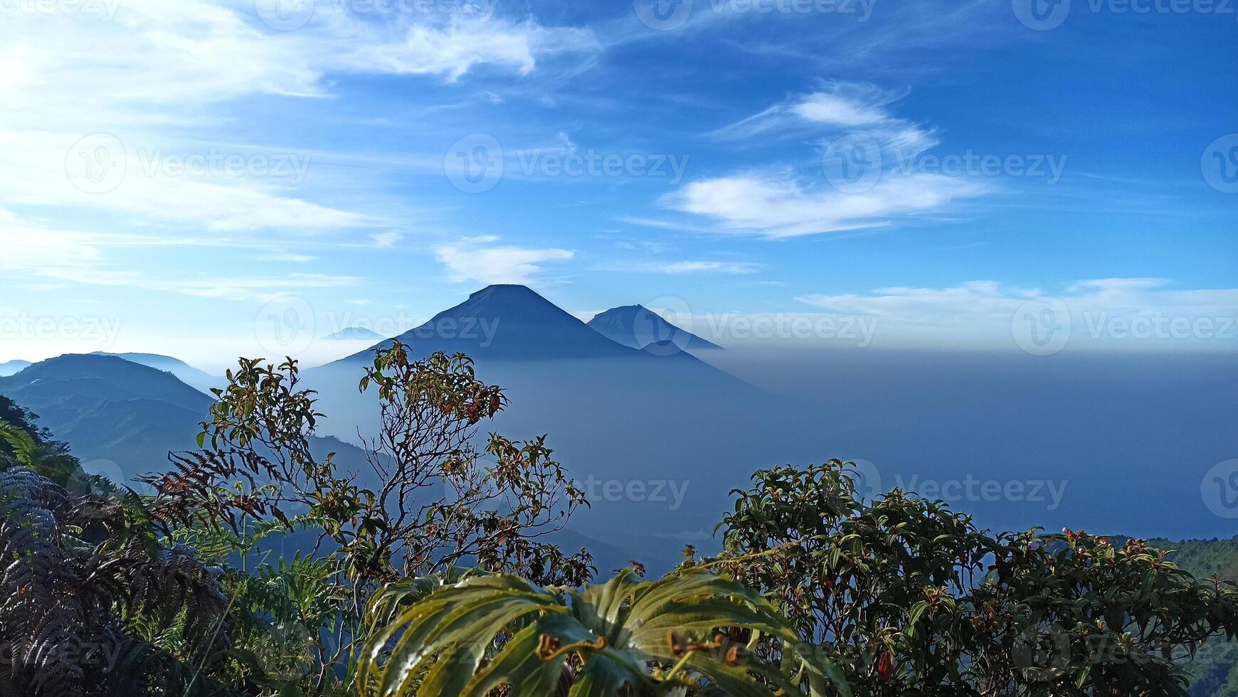 Natural views of Mount Sindoro and Mount Sumbing taken from the peak of Mount Bismo, Dieng, Wonosobo, Central Java in the morning, suitable for use as a natural background photo