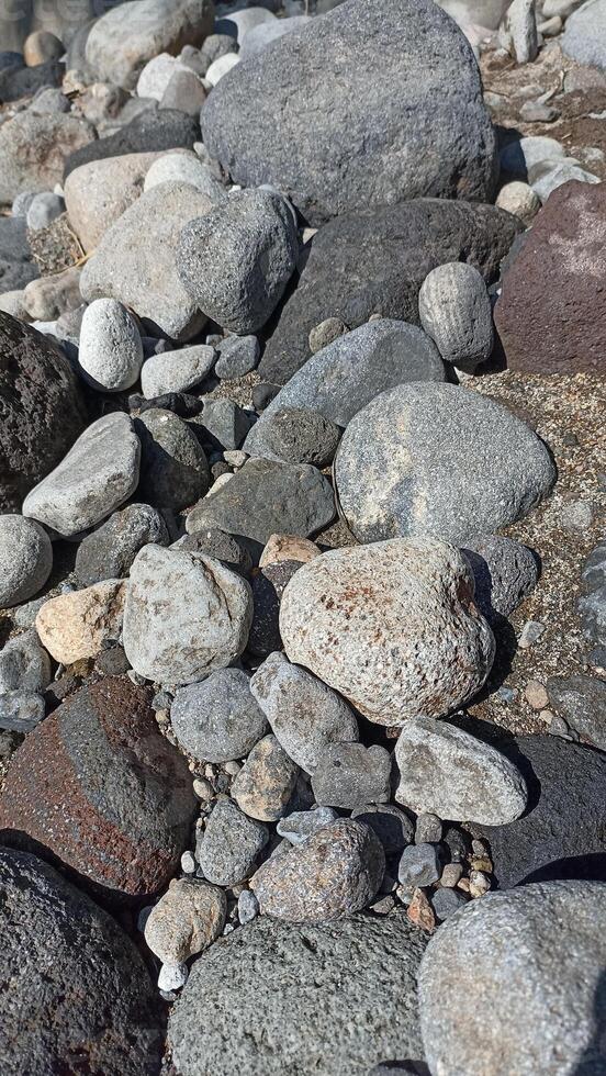 A collection of medium-sized river rocks is usually used as a mixture of building construction materials photo
