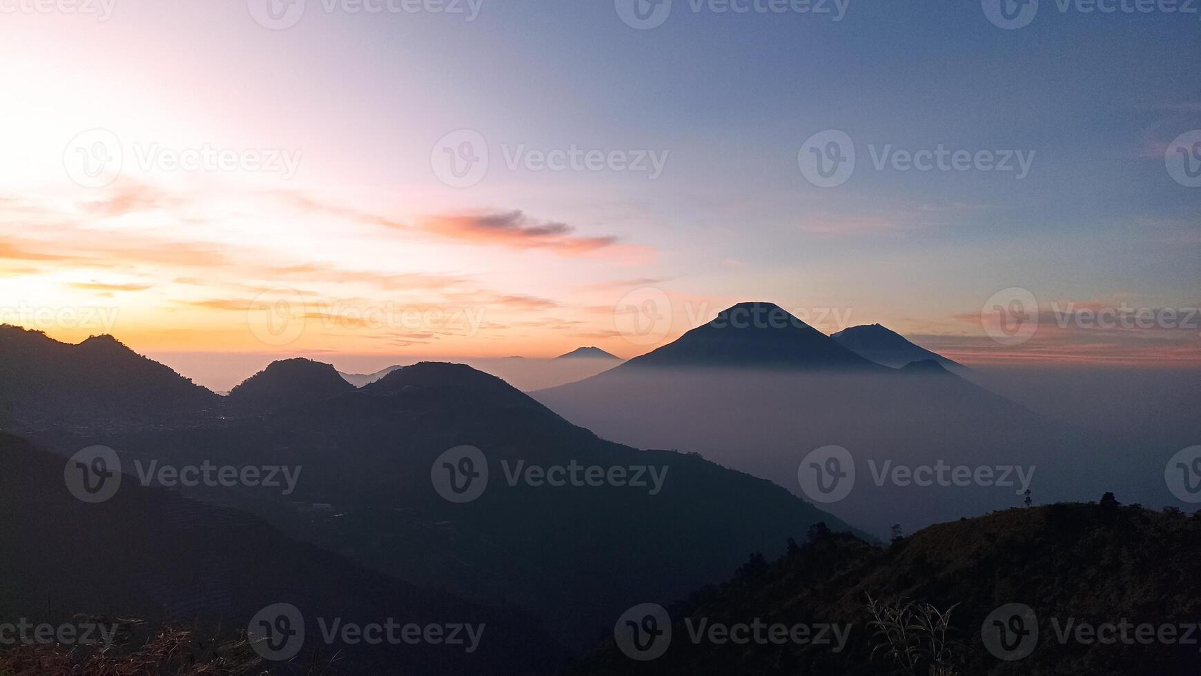 Natural views of Mount Sindoro and Mount Sumbing taken from the peak of Mount Bismo, Dieng, Wonosobo, Central Java in the morning, suitable for use as a natural background photo