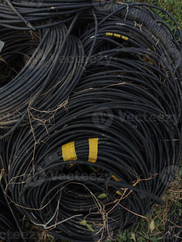 a bunch of used black cables that are not used anymore photo