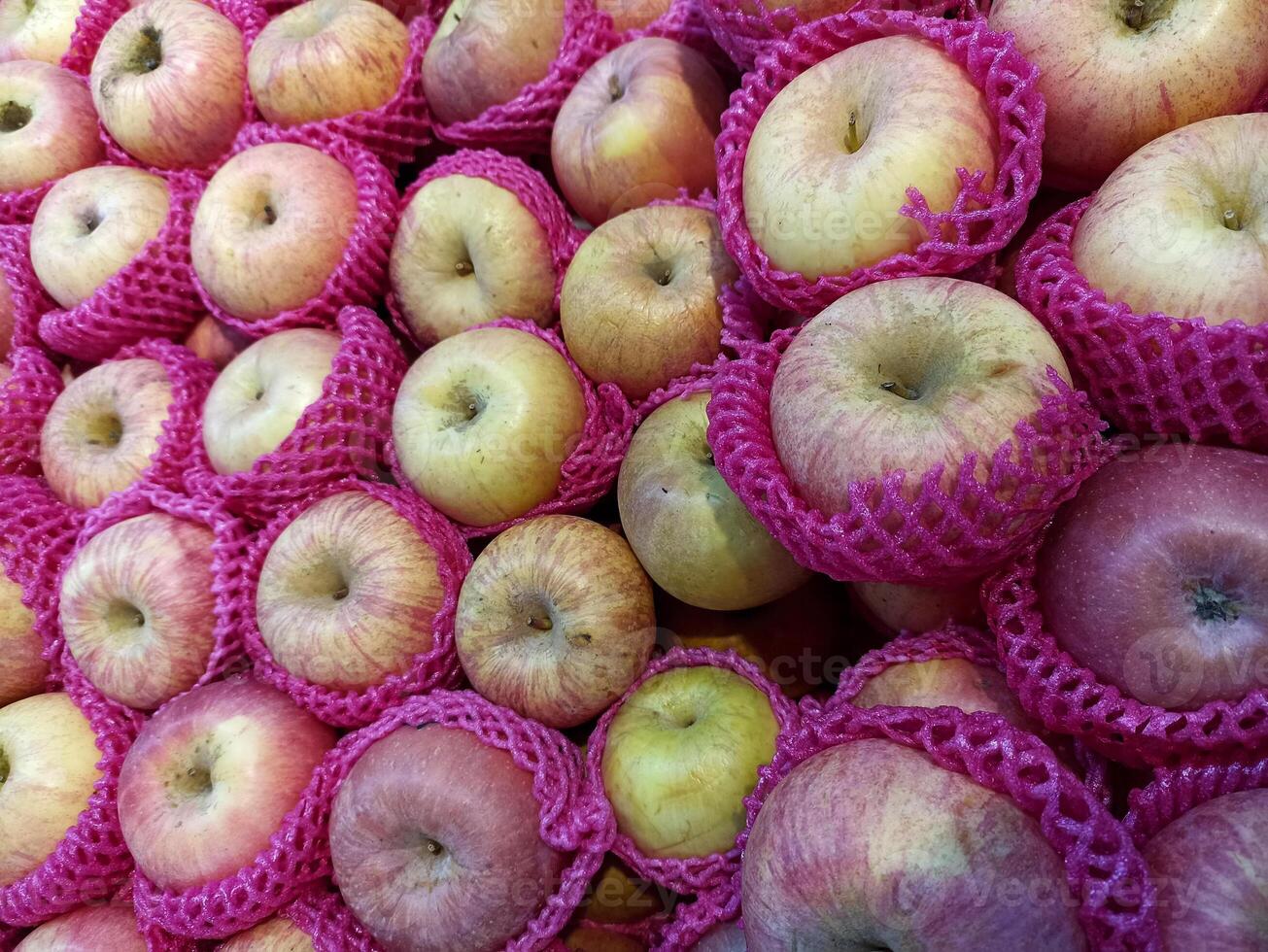a collection of neatly arranged apples ready to be sold in the market photo