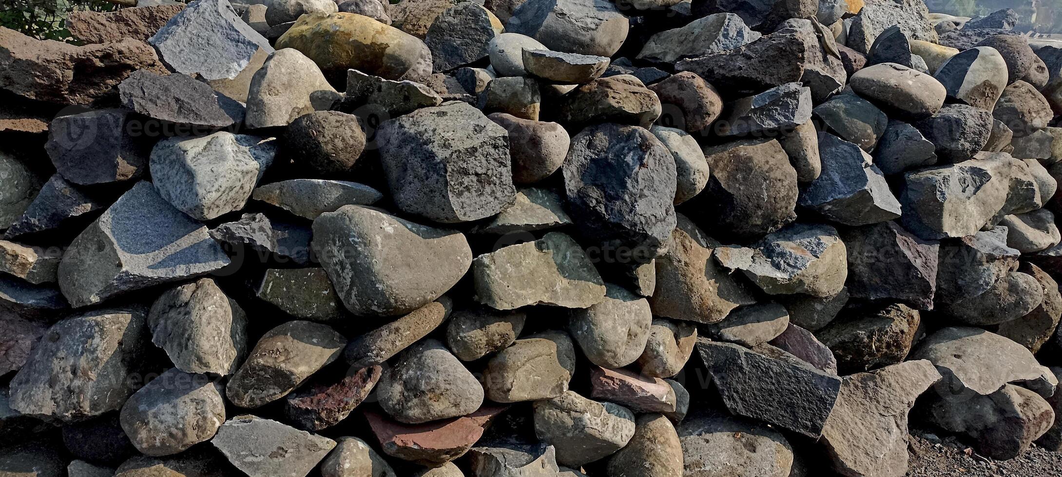 pile of stones that have been broken down and neatly arranged to be used for building foundations photo