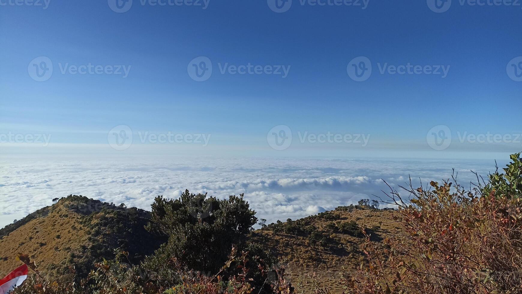 The view of the sea of clouds with blue sky from the top of mount lawu is suitable for use as a background with a natural theme photo