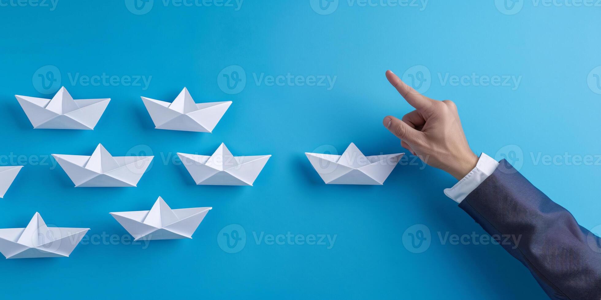 A hand holding paper ships symbolize sending a message or business ideas and flag ship photo