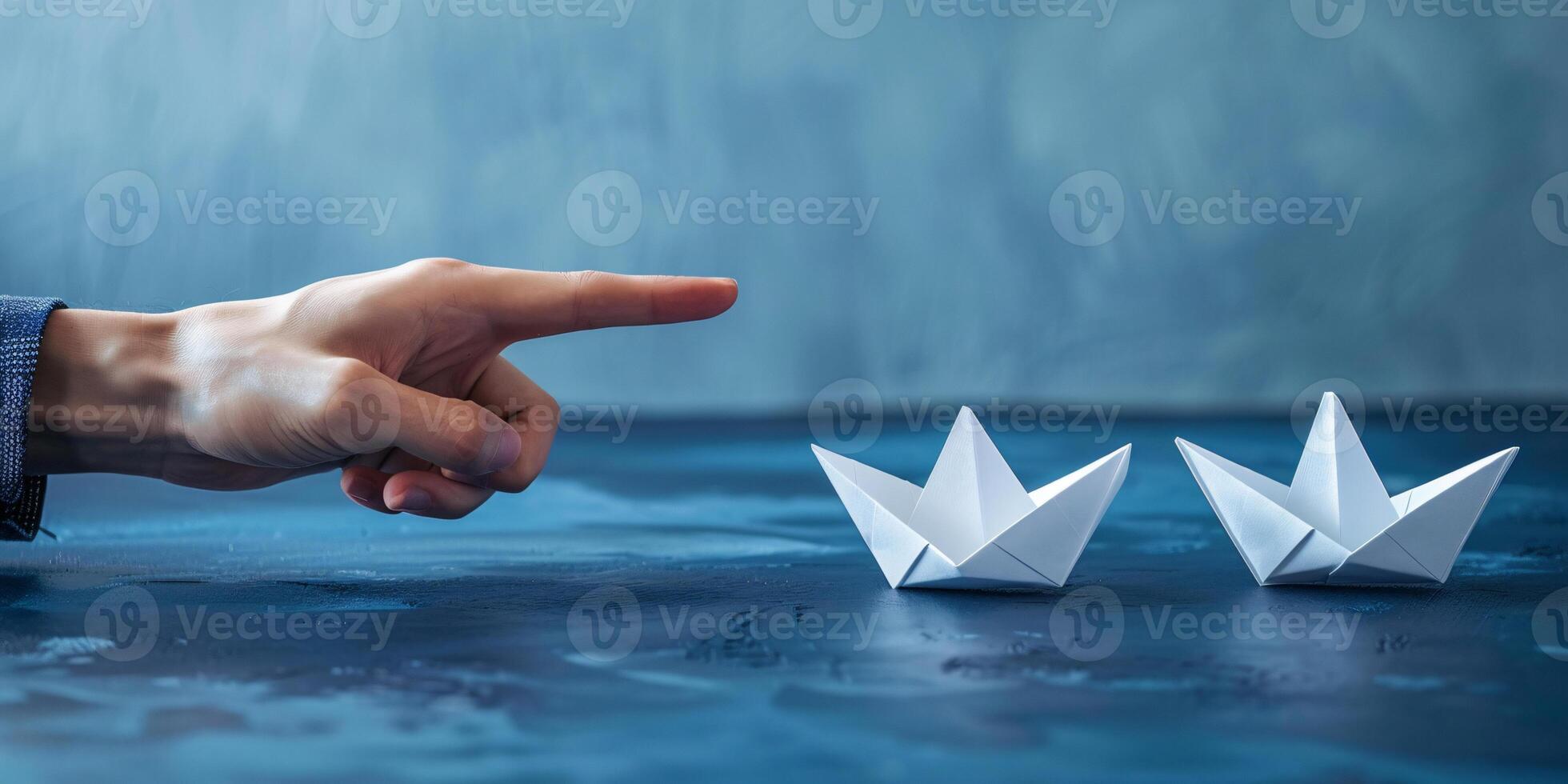 A hand holding paper ships symbolize sending a message or business ideas and flag ship photo