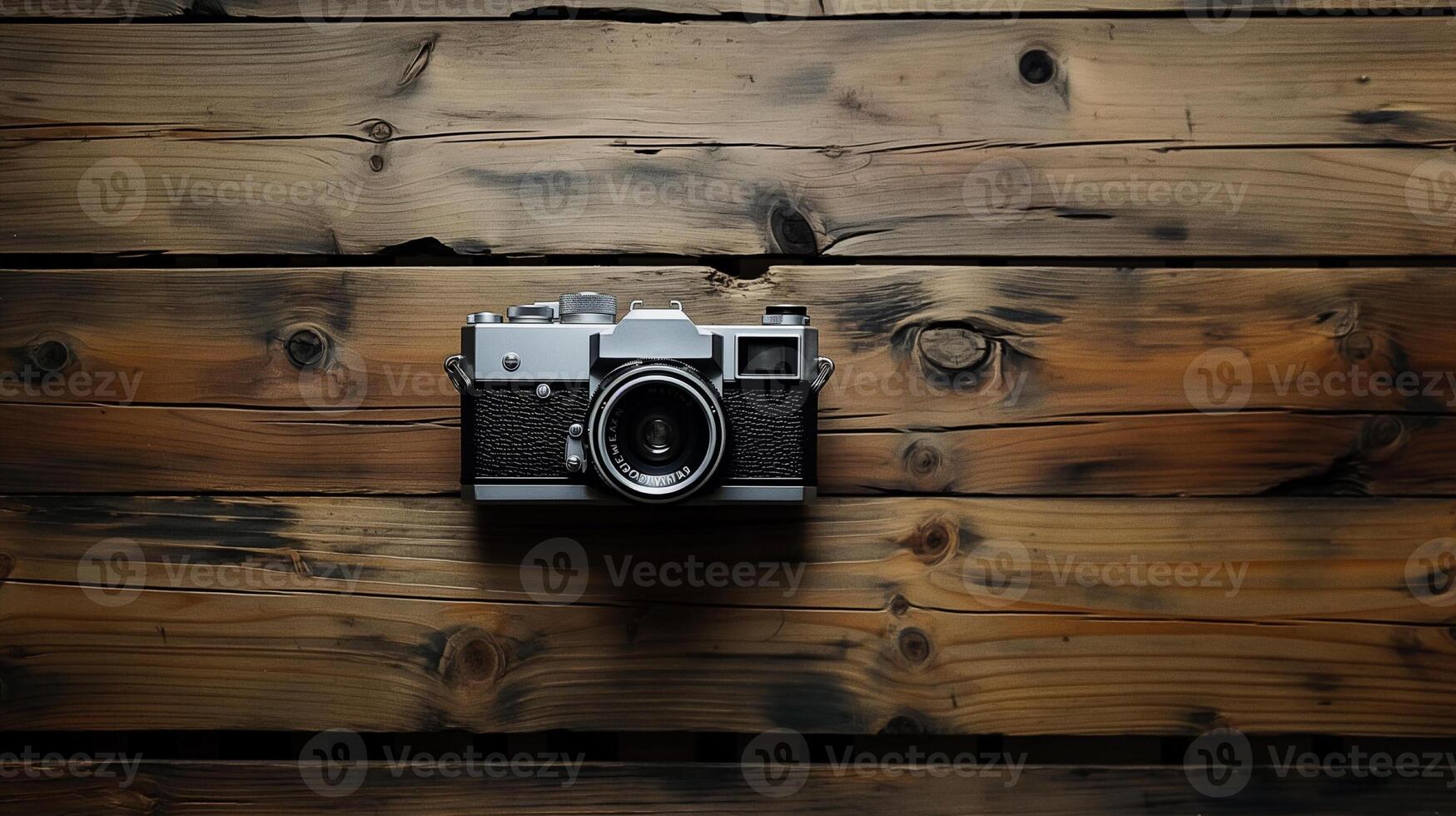 Camera lying on a wooden plain surface on beautiful background, top view photo
