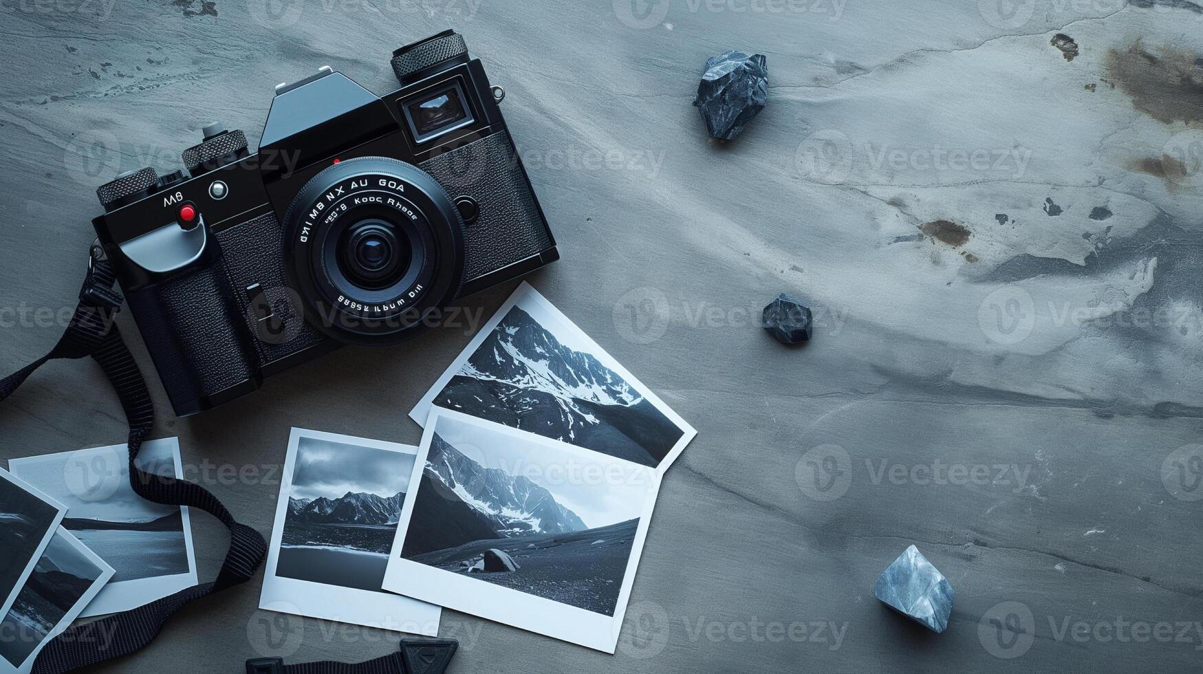 Camera and photographs lying on a plain surface on beautiful background, top view photo