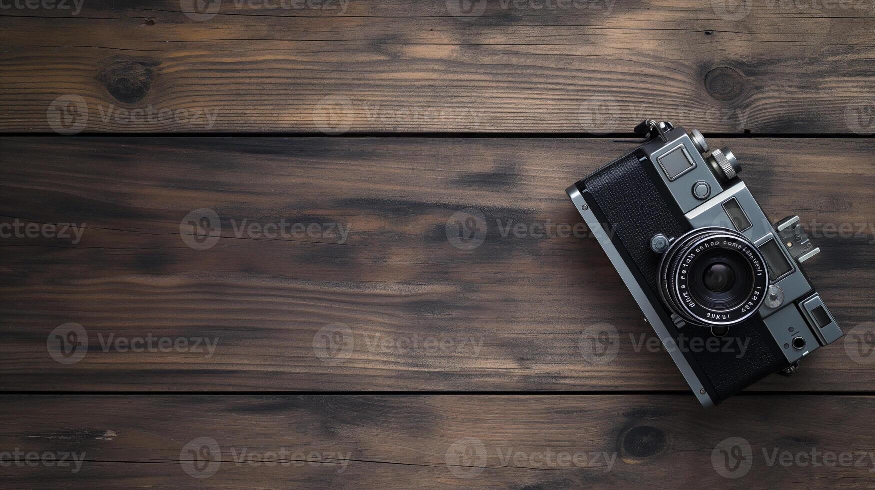 Camera lying on a wooden plain surface on beautiful background, top view photo
