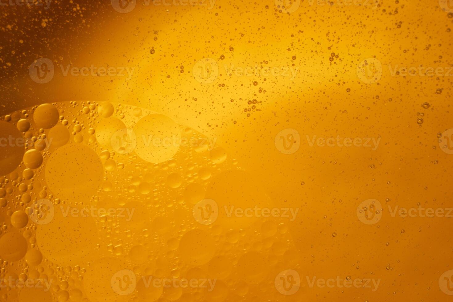 Yellow oil bubbles on water, cooking oil background. photo