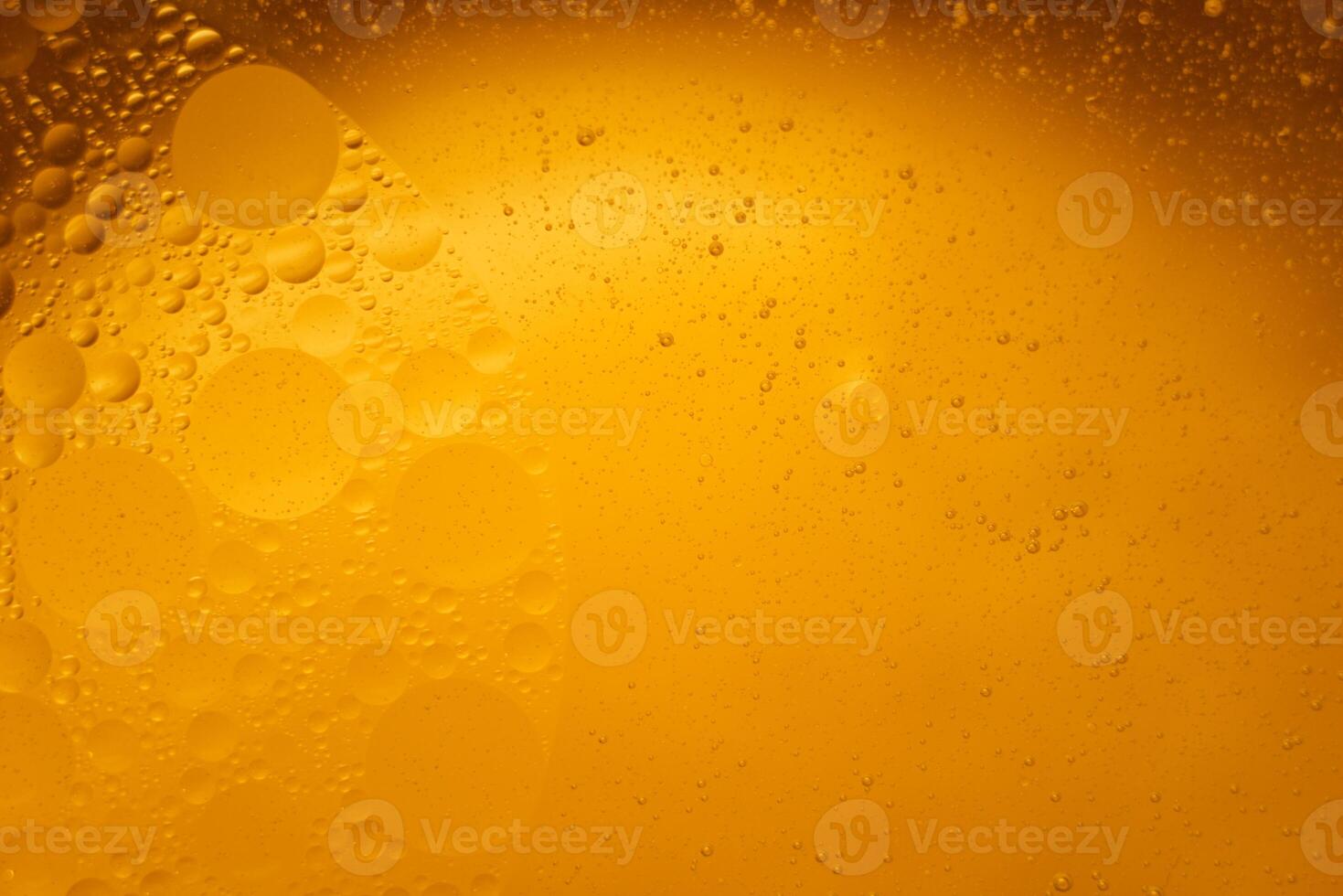 Yellow oil bubbles on water, cooking oil background. photo