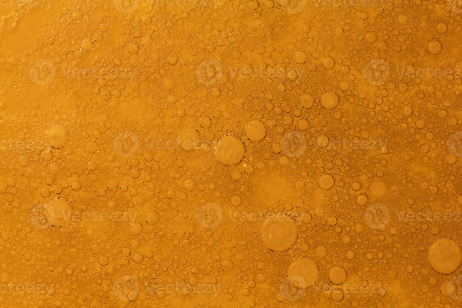 Cooking oil, water with oil emulsions and bubbles in the background. photo
