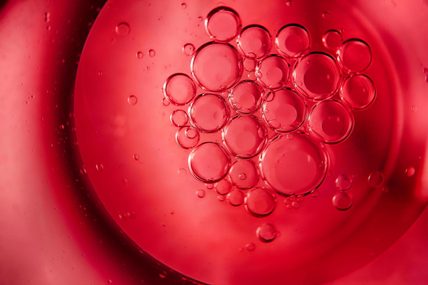 Red bubbles and drops of water on a white background star from an American flag. photo