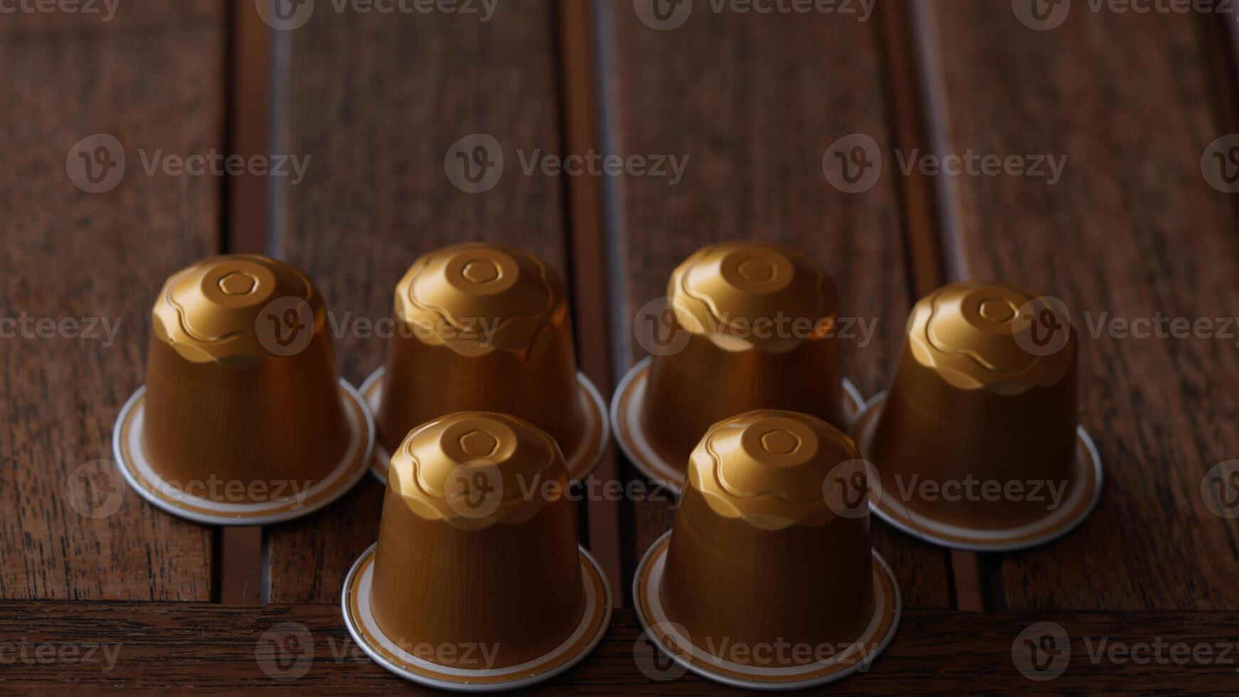 a group of six golden coffee cups sitting on a table photo