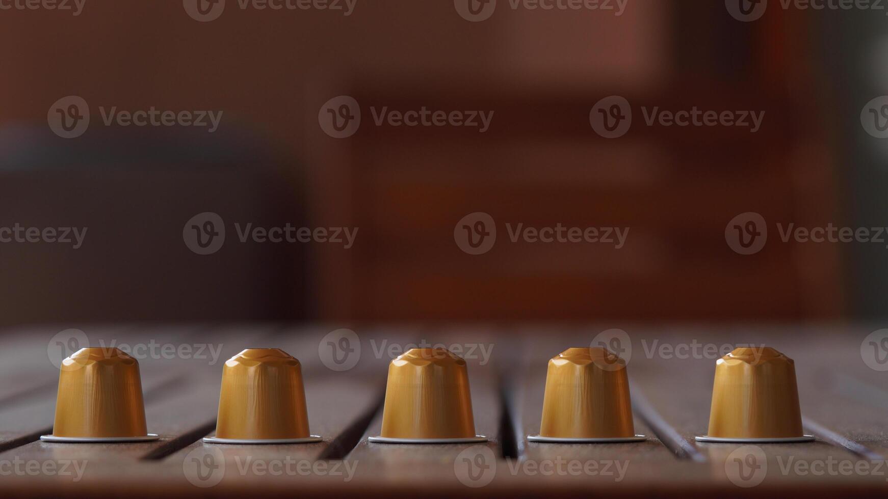 a row of coffee capsules on a table photo