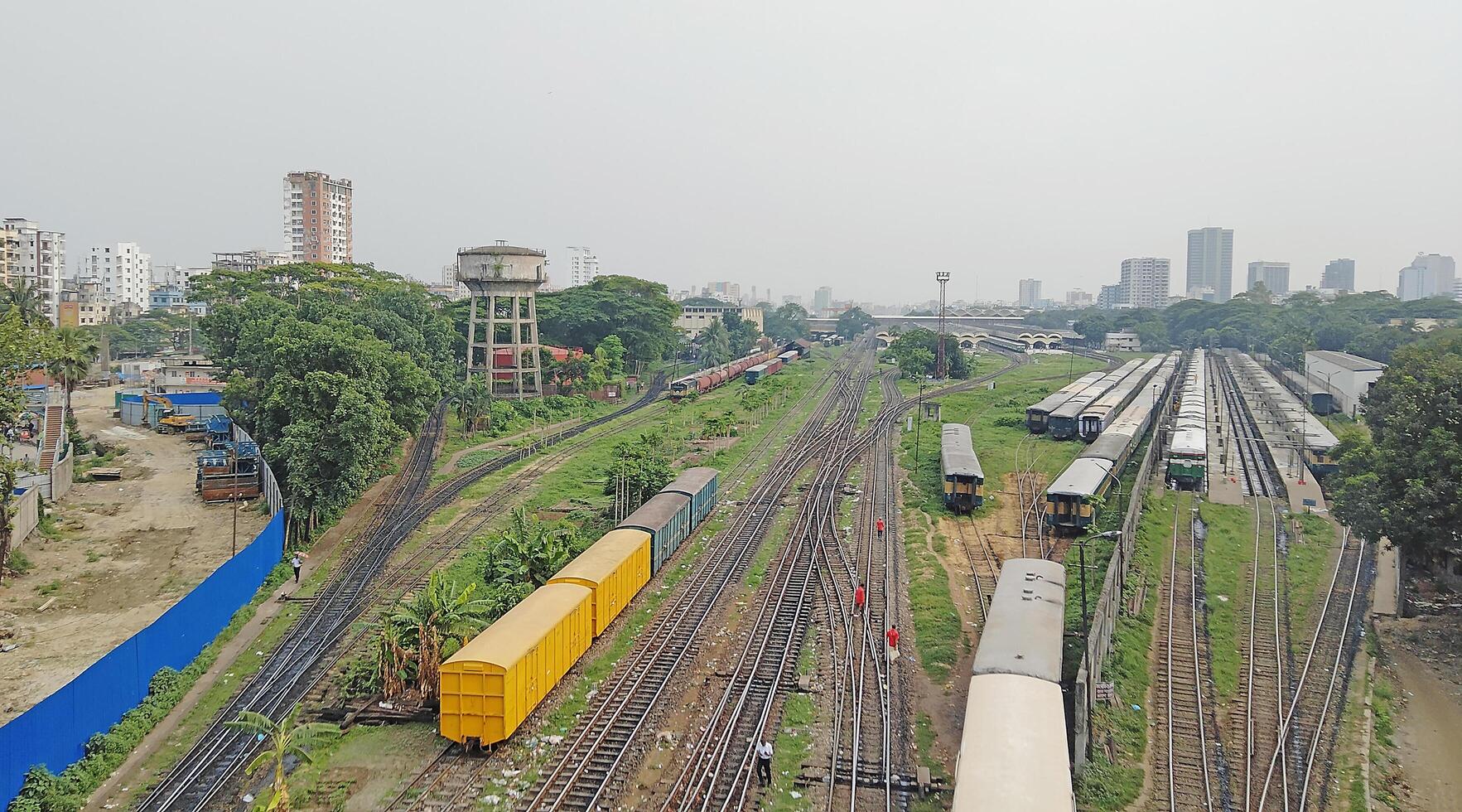 Surface level of railway tracks along green plants photo