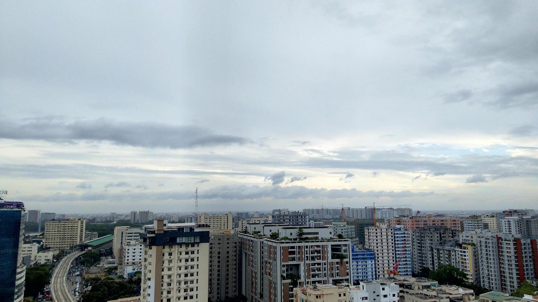Wide shot of a modern and busy city with dark clouds photo