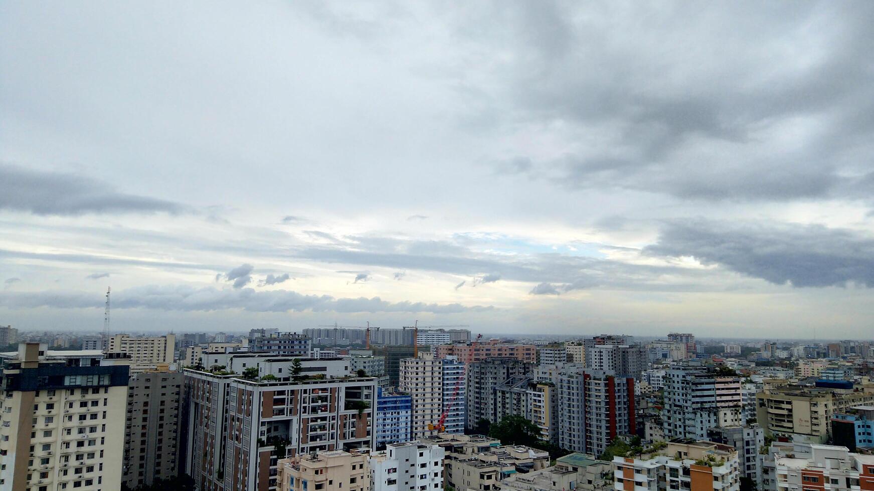 Wide shot of a modern and busy city with dark clouds photo