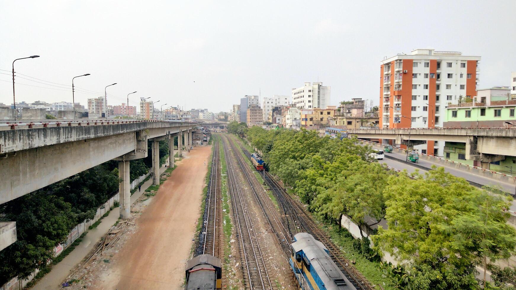 Surface level of railway tracks along green plants photo