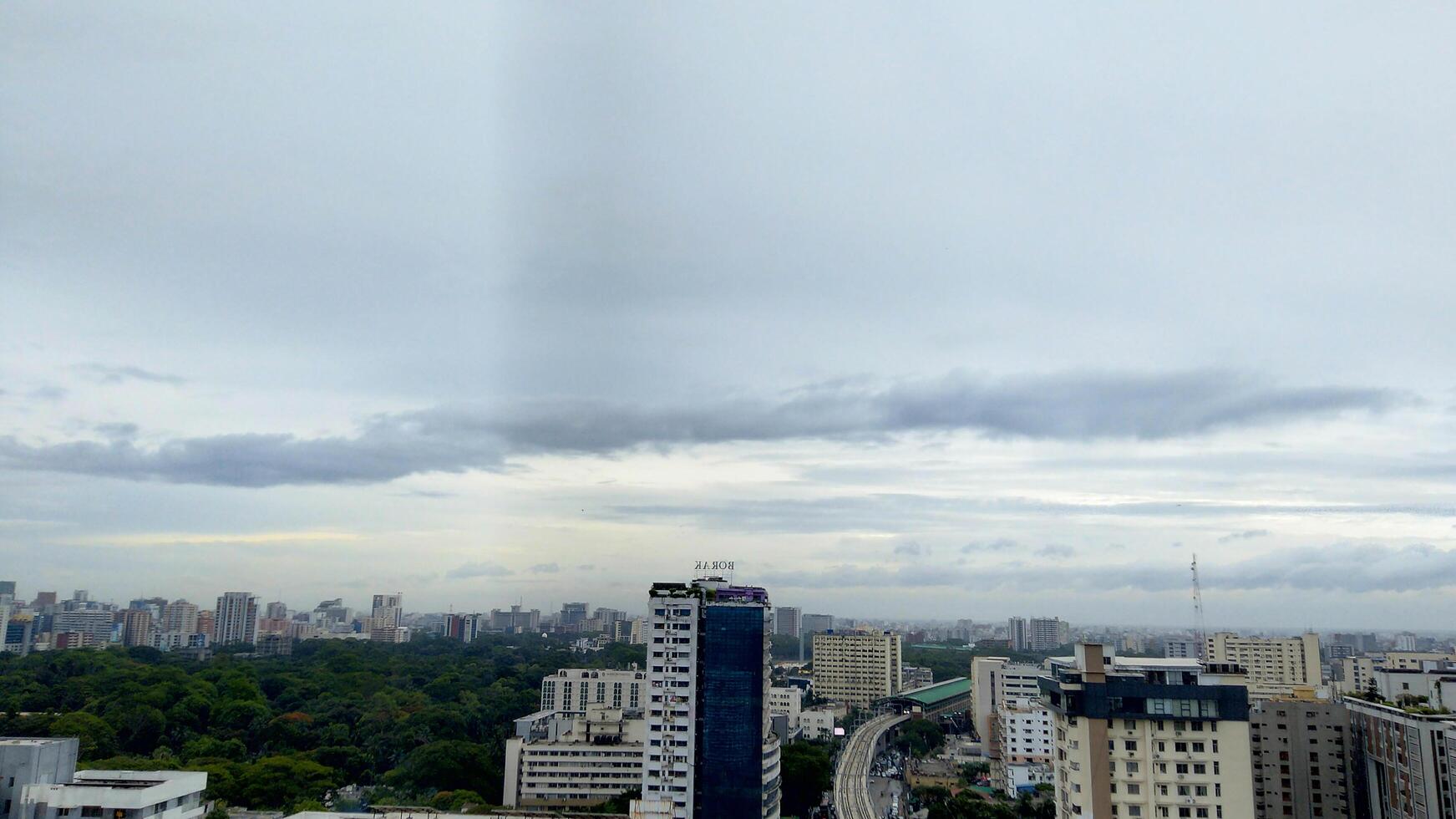 Wide shot of a modern and busy city with dark clouds photo