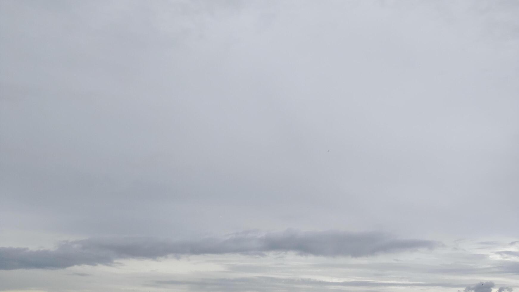 Wide shot of a modern and busy city with dark clouds photo