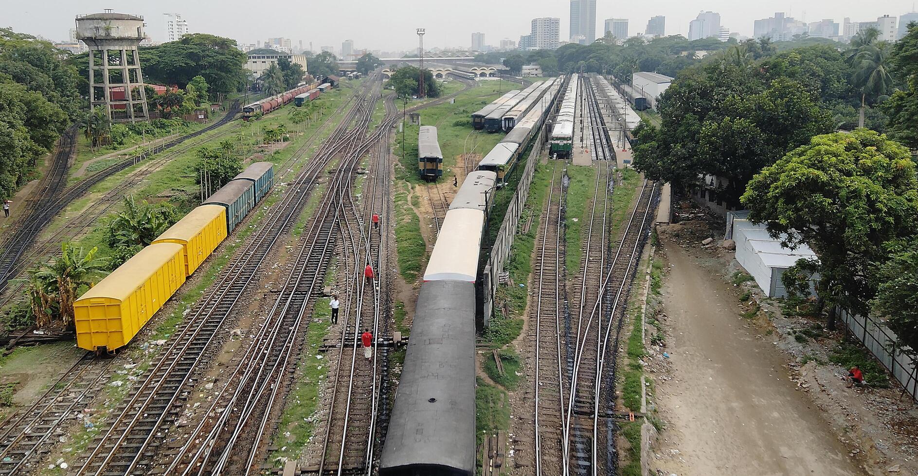 Surface level of railway tracks along green plants photo