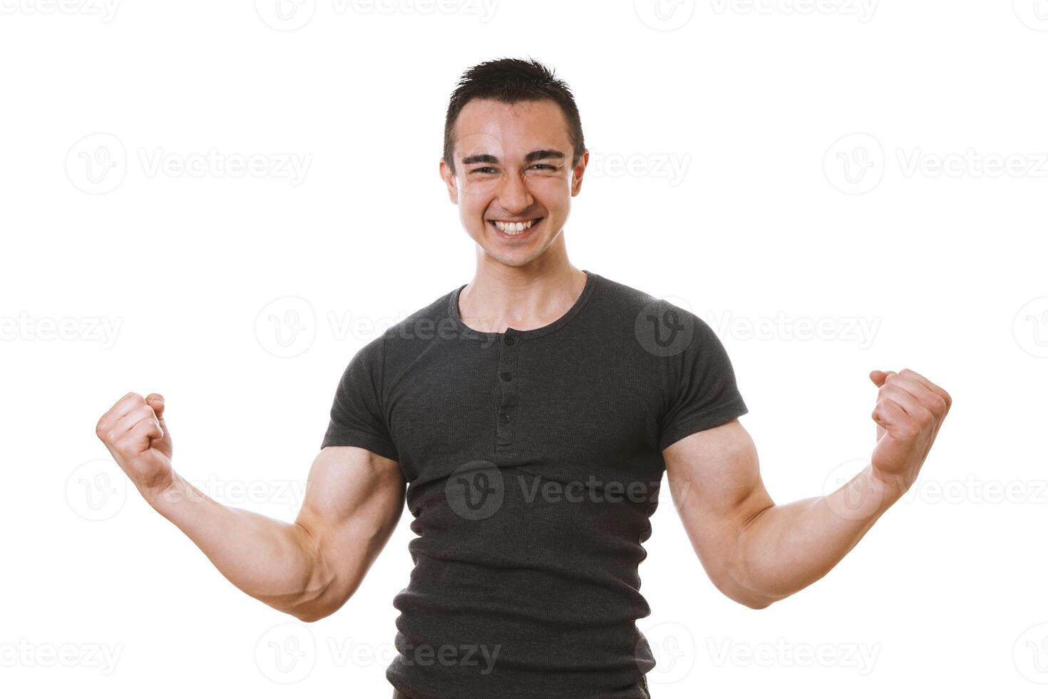 muscular young man celebrating success in winner pose photo