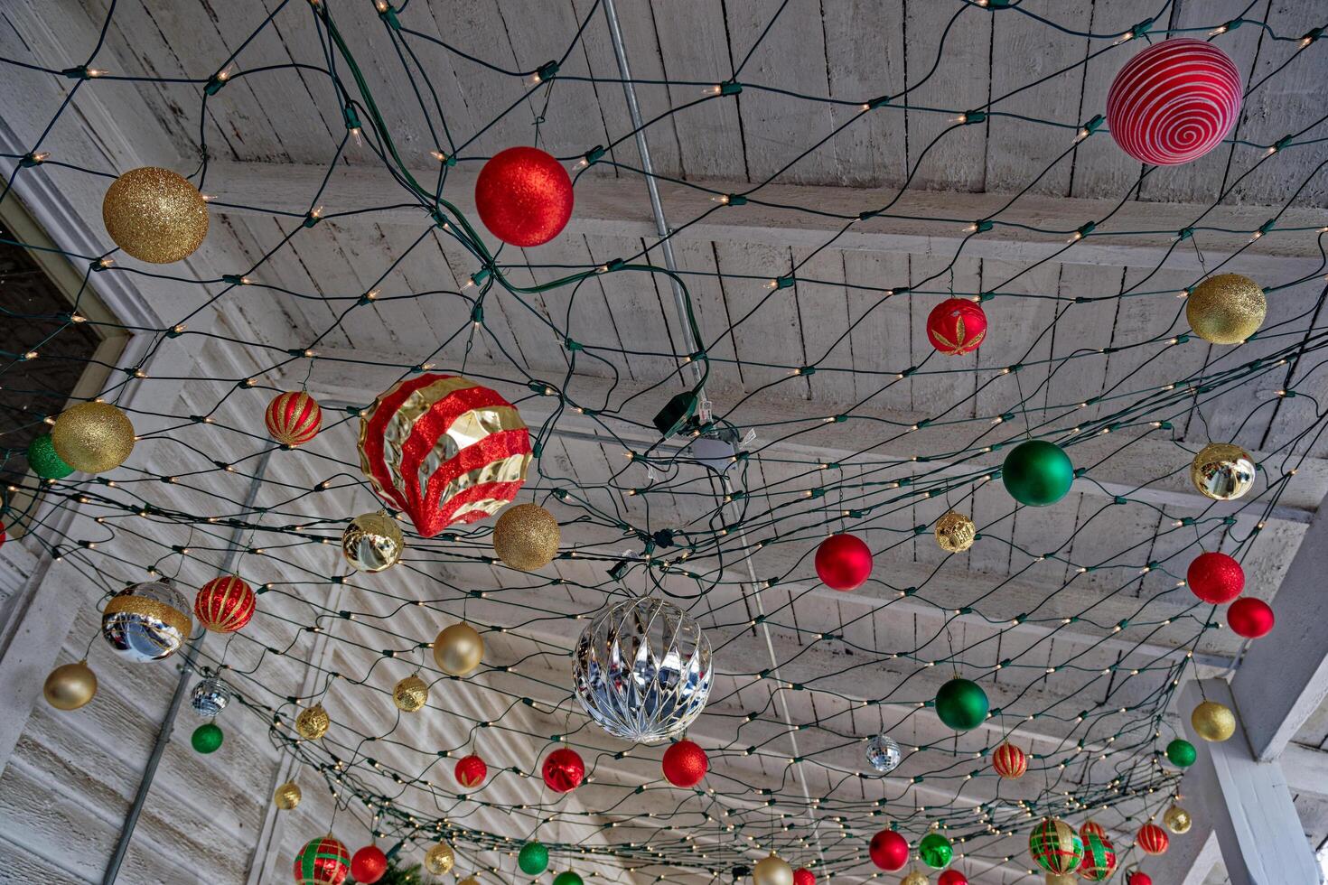 Ornaments hanging under a porch roof photo