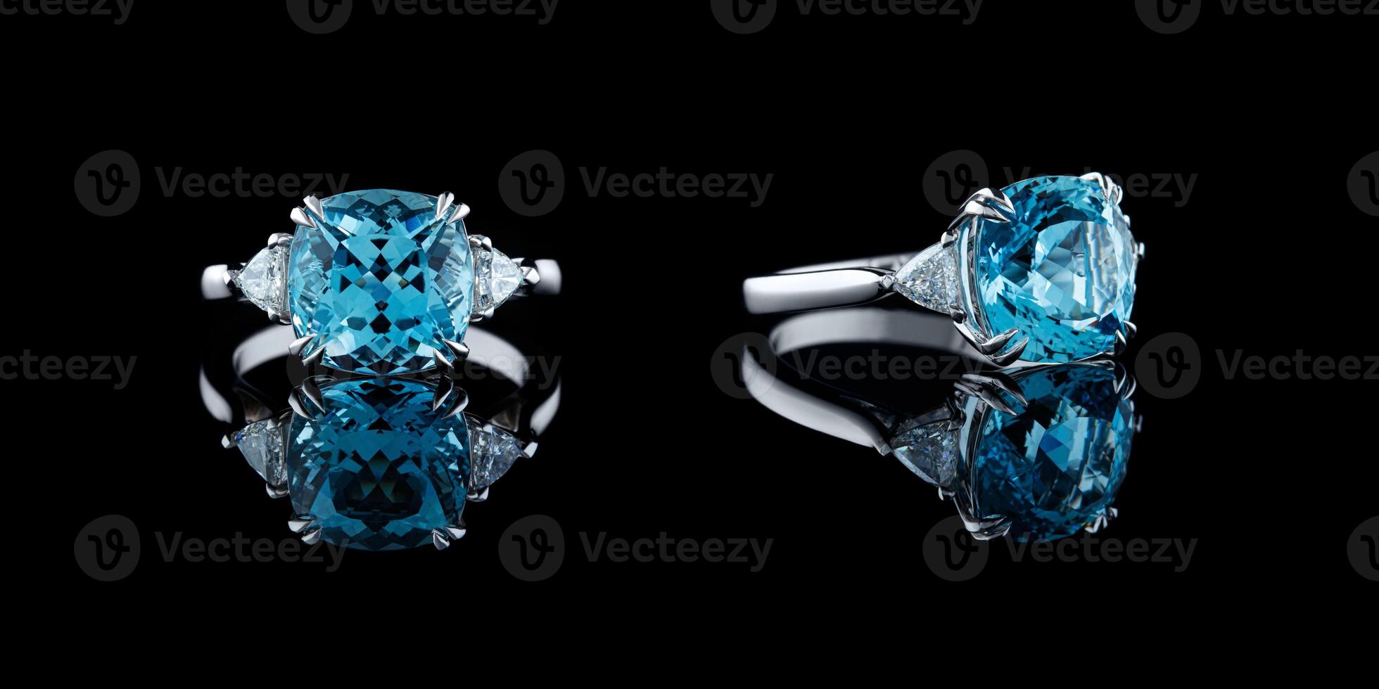 Beautiful gold ring with aquamarine and diamonds on a black background photo