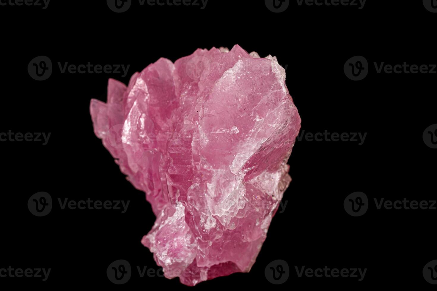 Macro pink quartz mineral stone on black background photo