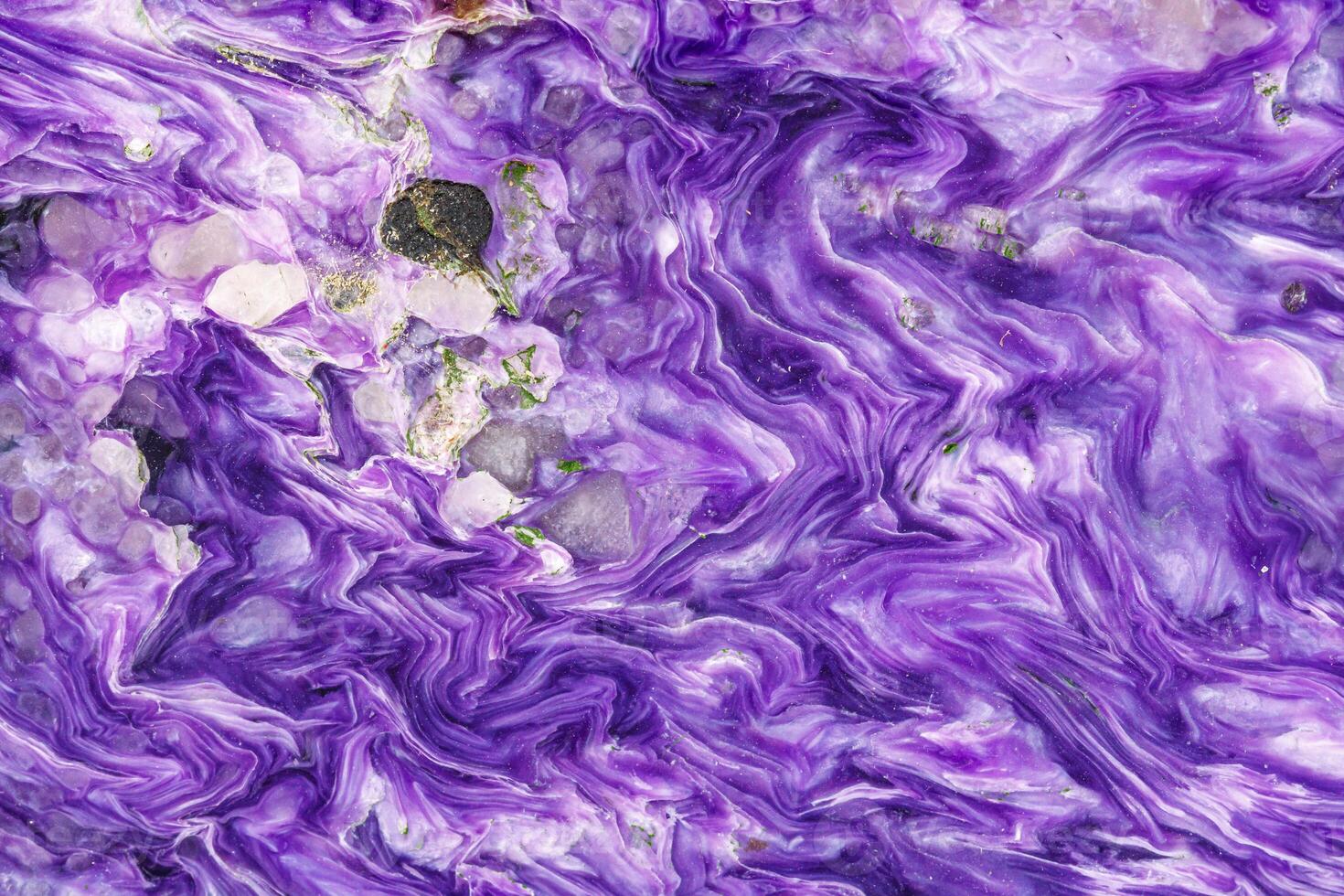 Macro stone Charoite mineral on white background photo
