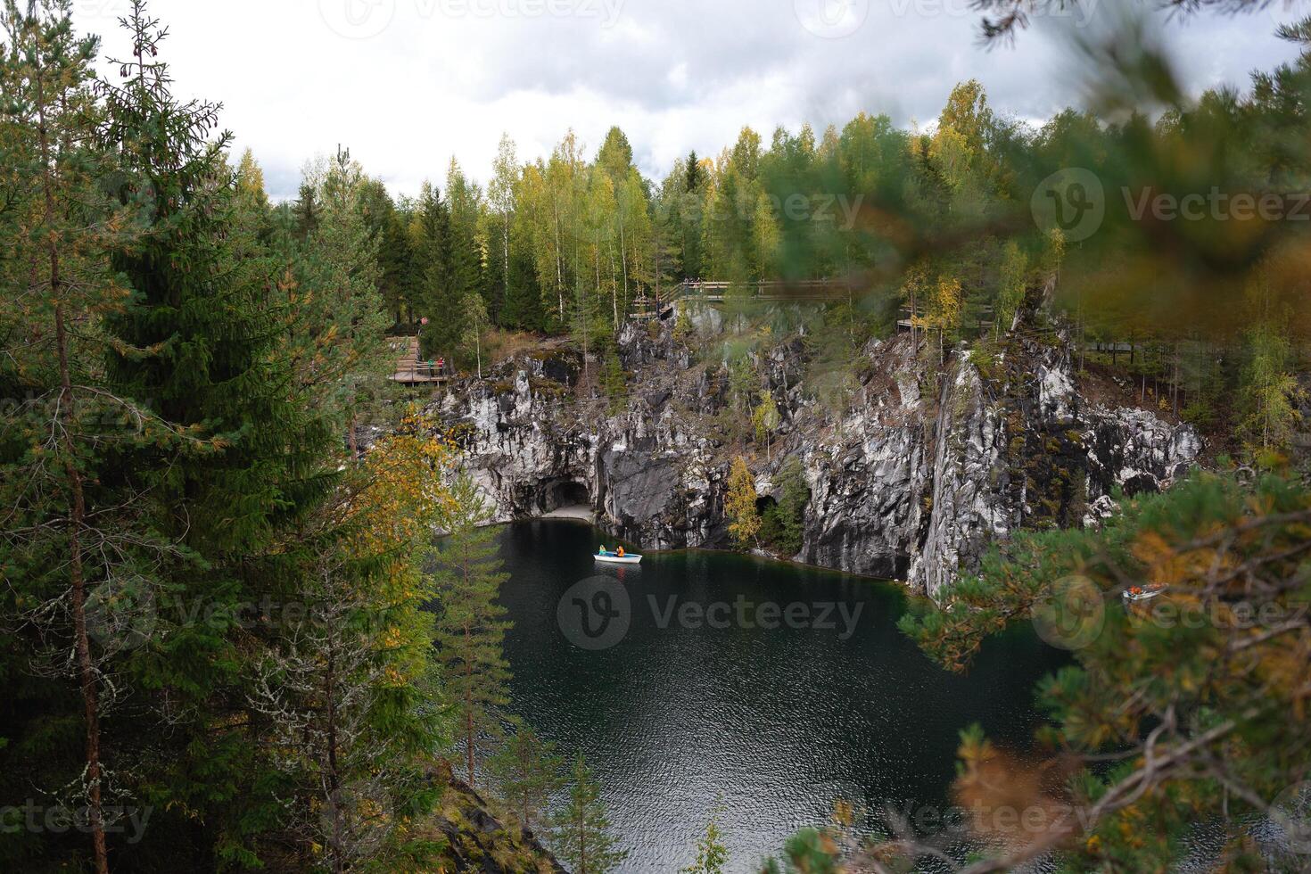boats floating on the lake in the marble canyon surrounded by autumn forest photo