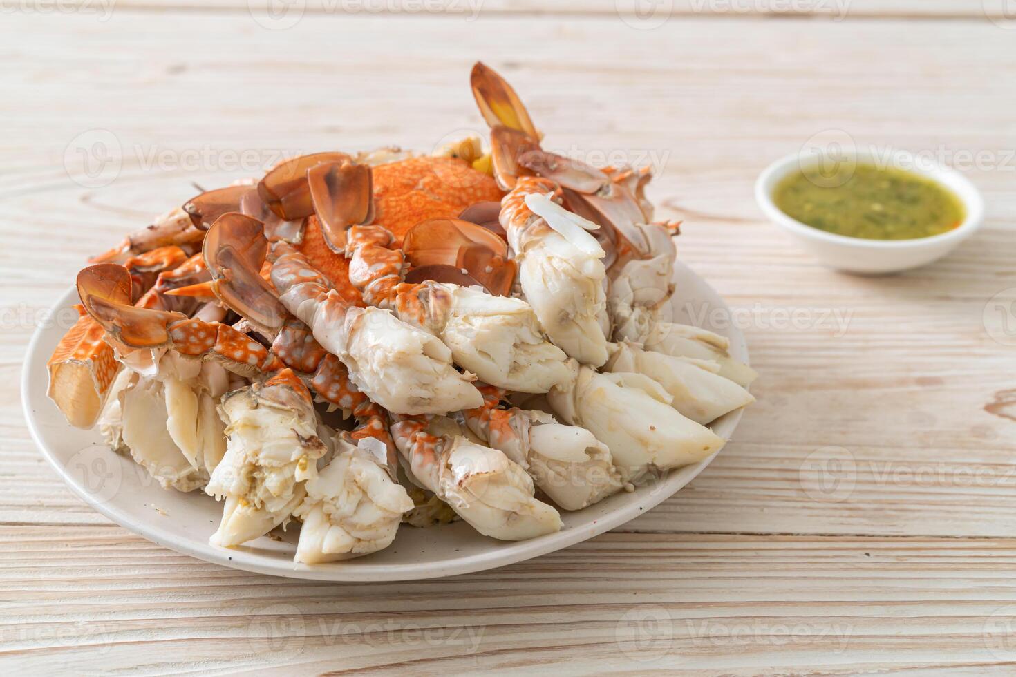 Steamed blue crab with spicy seafood sauce photo