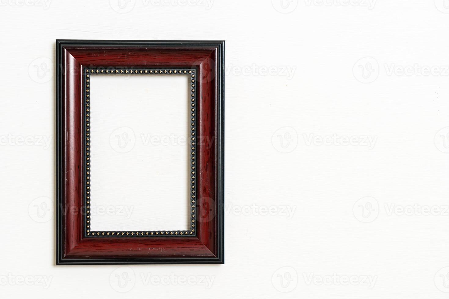 empty picture frame on white wall background photo