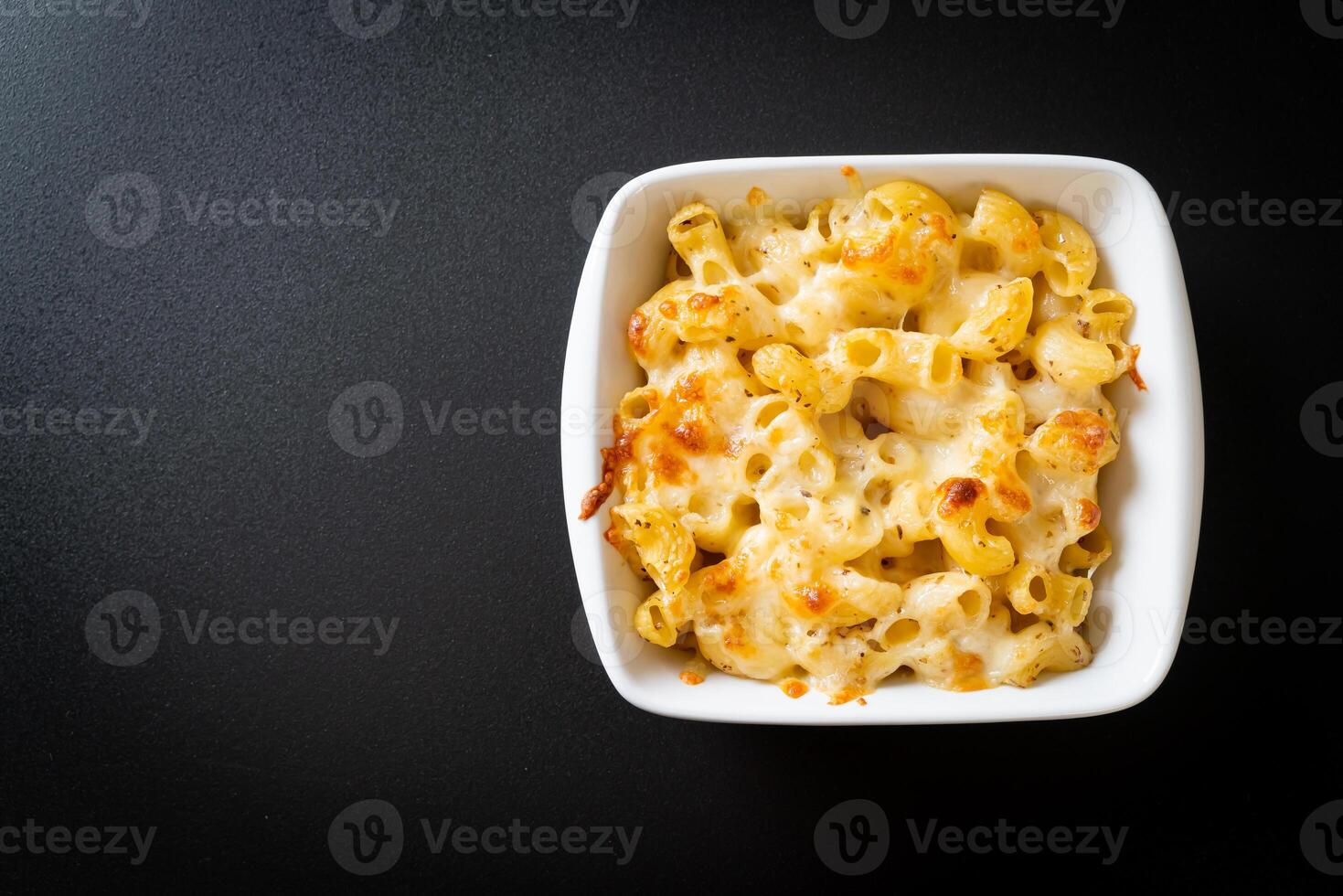 American mac and cheese, macaroni pasta in cheesy sauce photo