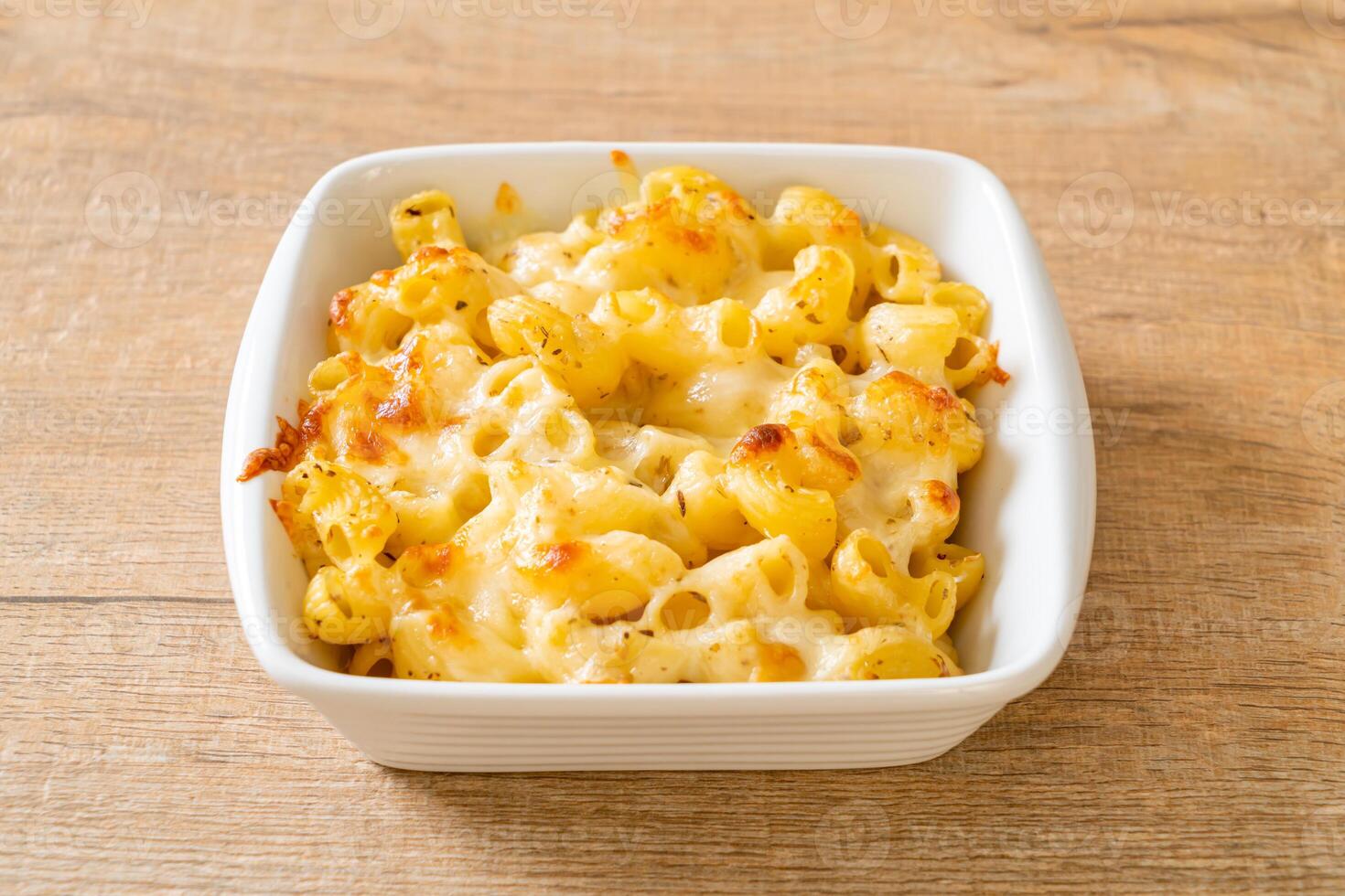 American mac and cheese, macaroni pasta in cheesy sauce photo