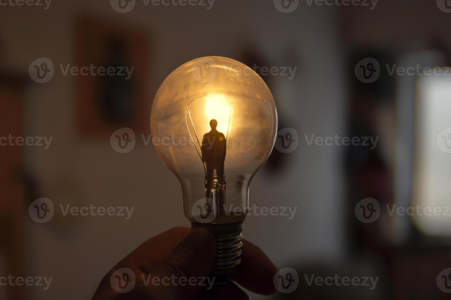 Creative concept photo of a light bulb with a man's silhouette glowing inside