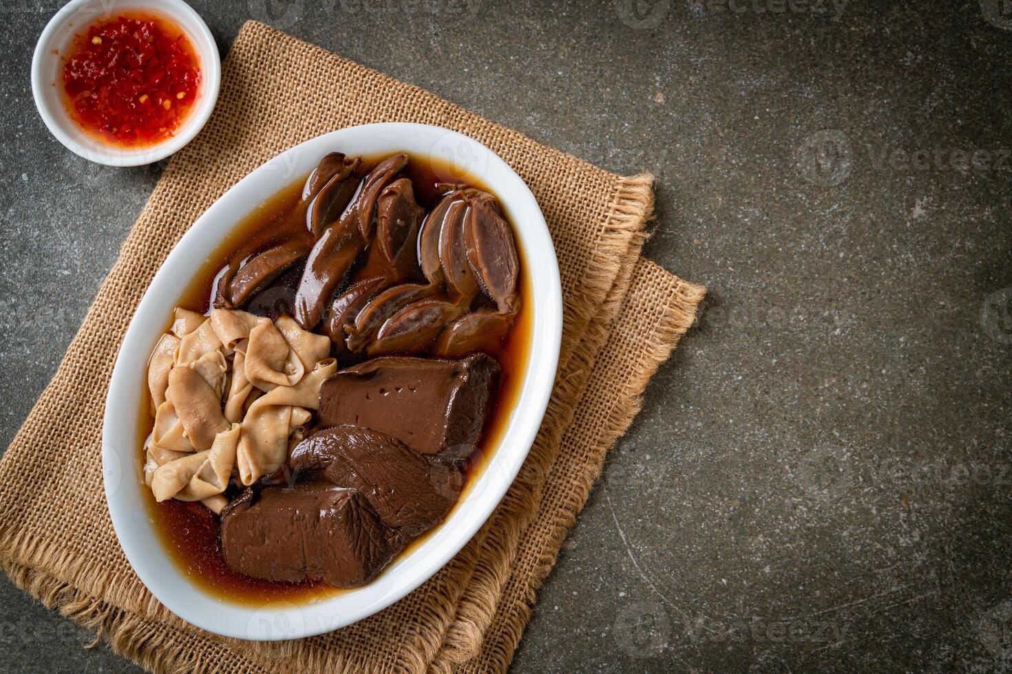 stewed duck offal in brown soup photo