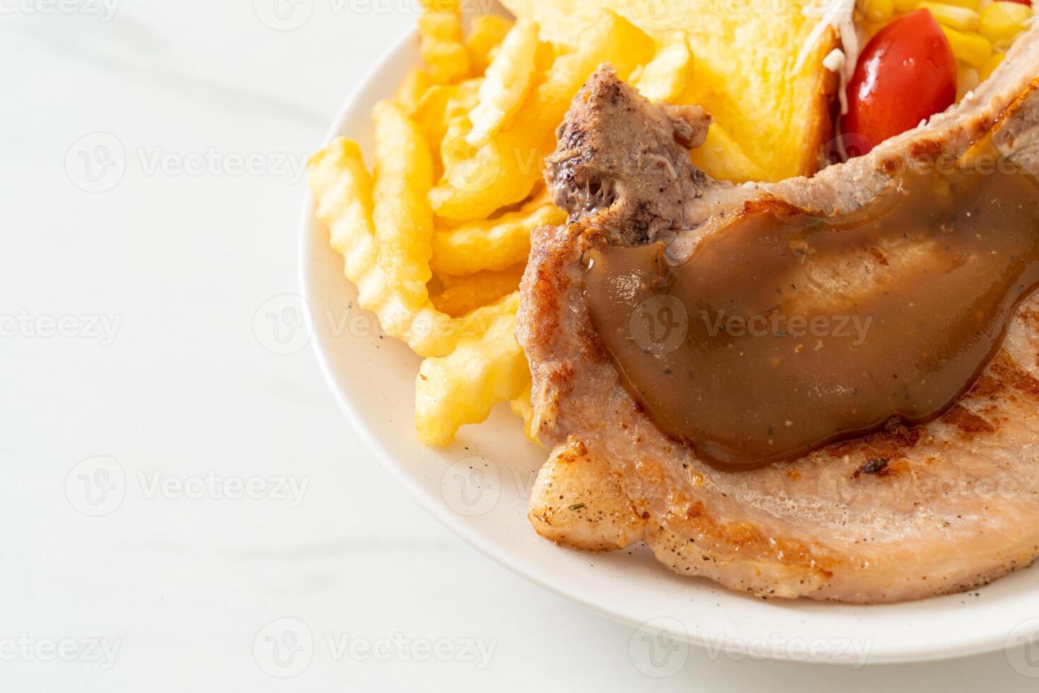 pork chop steak with chips and mini salad photo