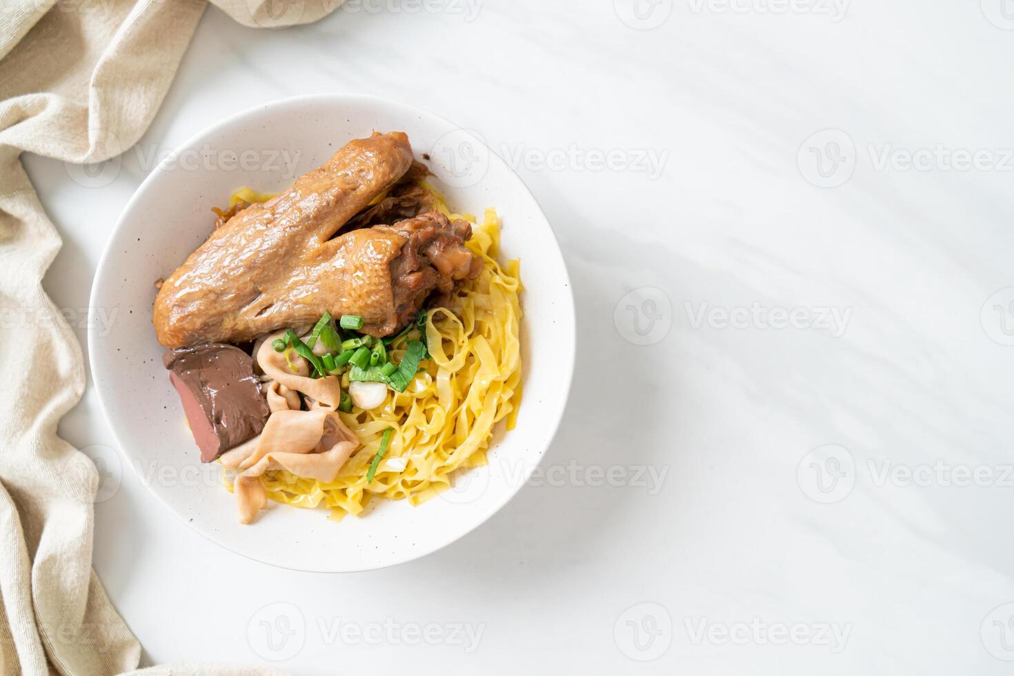 Egg noodles served dry with braised duck photo