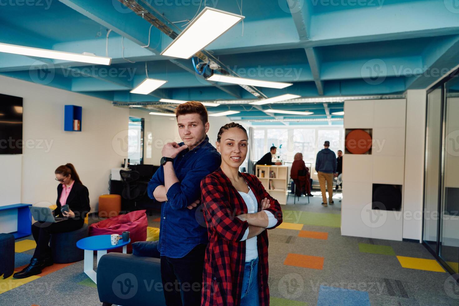 Portrait of a successful creative businessman and businesswoman looking at camera and smiling. Diverse business people standing together at startup. photo