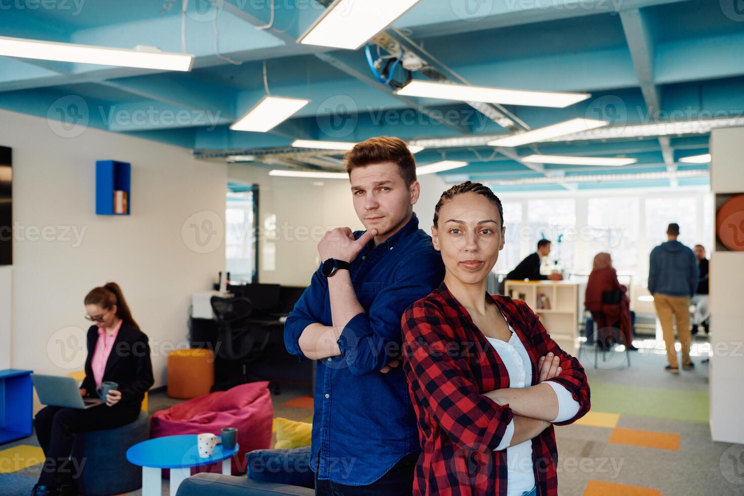 Portrait of a successful creative businessman and businesswoman looking at camera and smiling. Diverse business people standing together at startup. photo