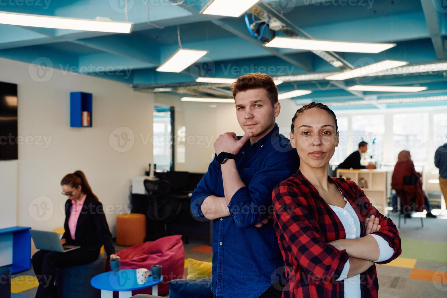 Portrait of a successful creative businessman and businesswoman looking at camera and smiling. Diverse business people standing together at startup. photo