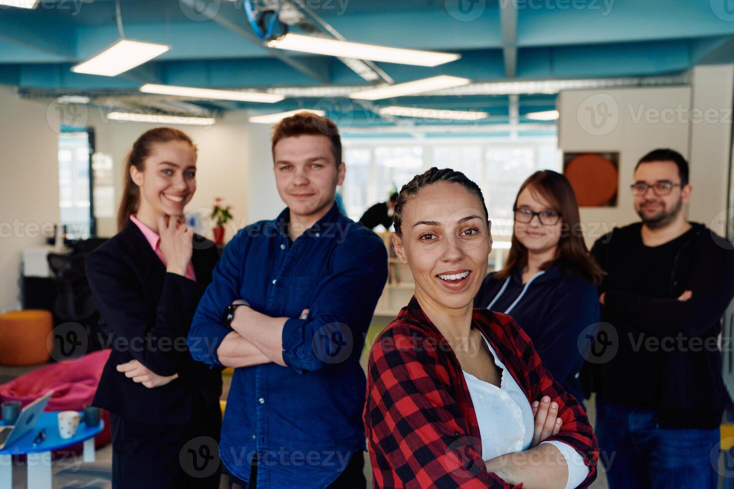 Portrait of a successful creative businessman and businesswoman looking at camera and smiling. Diverse business people standing together at startup. photo