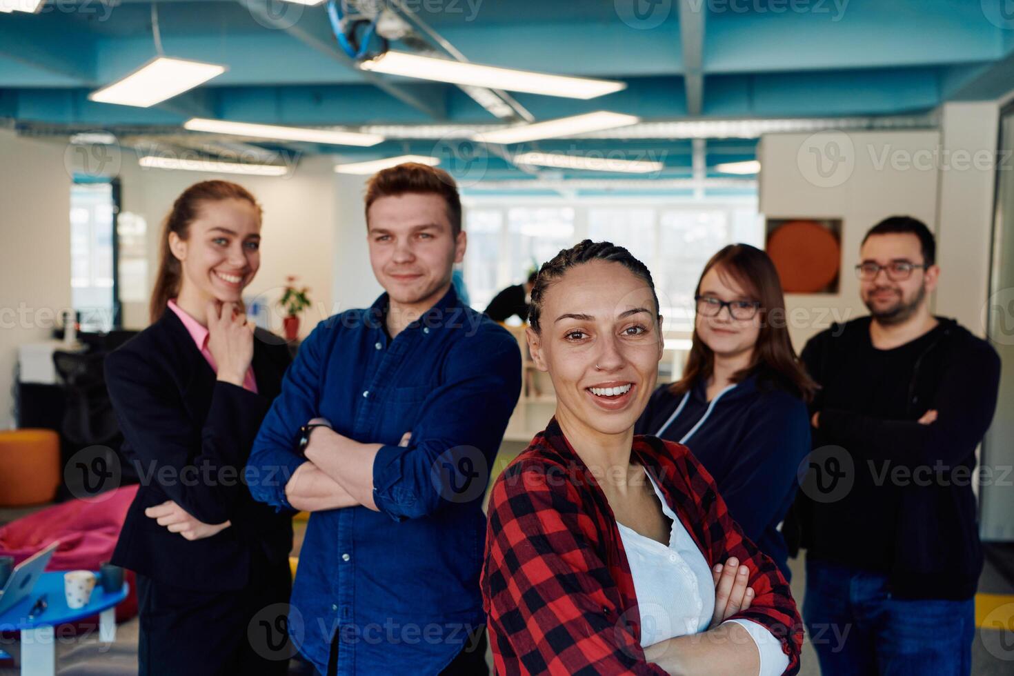 Portrait of a successful creative businessman and businesswoman looking at camera and smiling. Diverse business people standing together at startup. photo