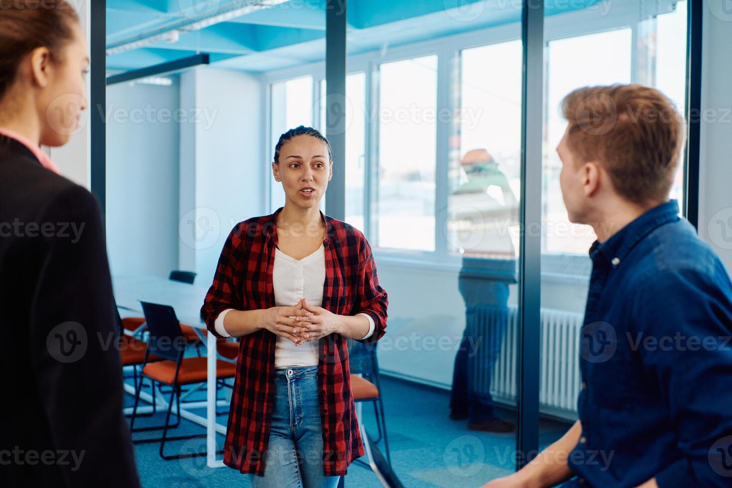 A diverse team of young business people exchanging ideas in a modern startup office photo