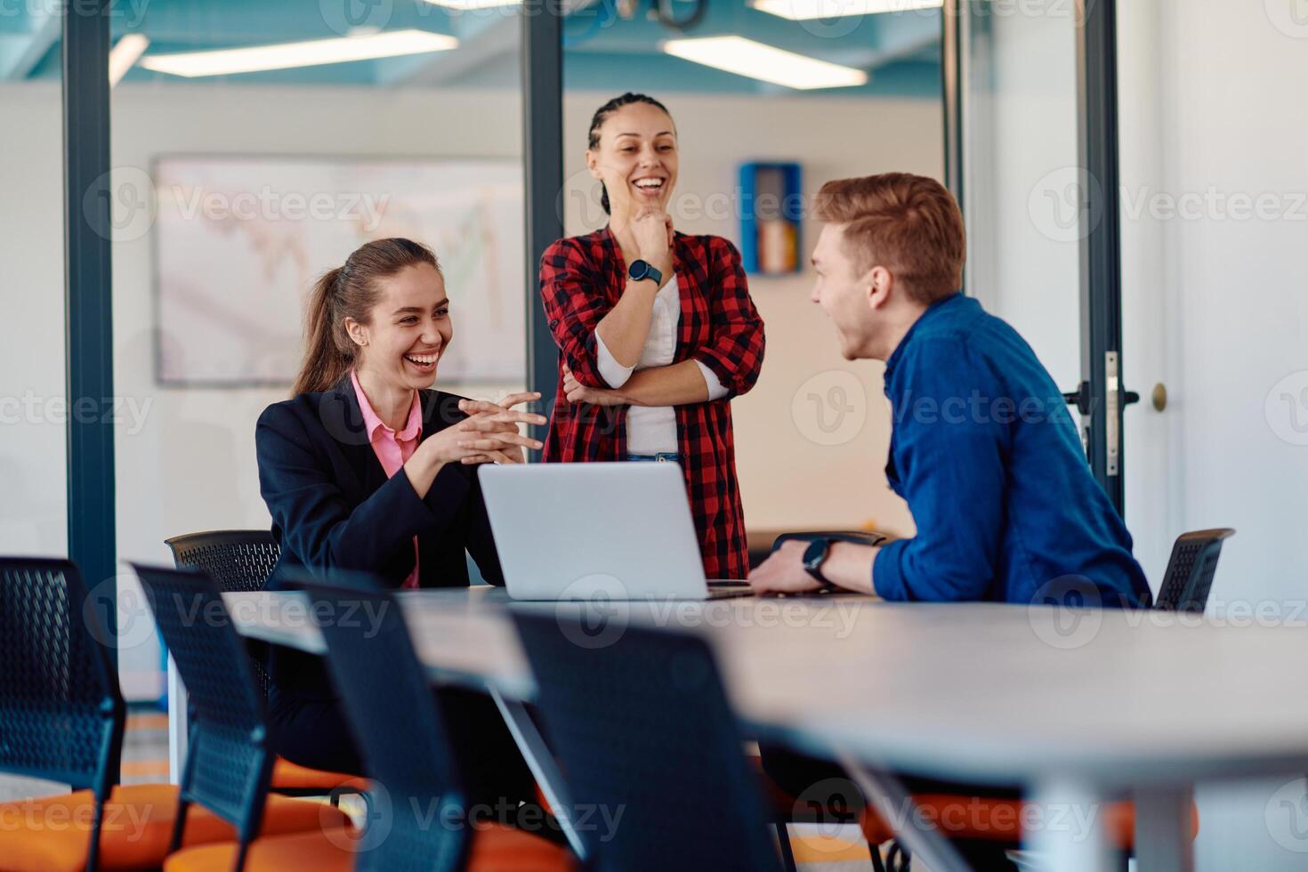 A team of successful programmers sits in a startup office, strategizing new business projects and solving existing challenges, showcasing innovation and collaboration in the tech industry photo