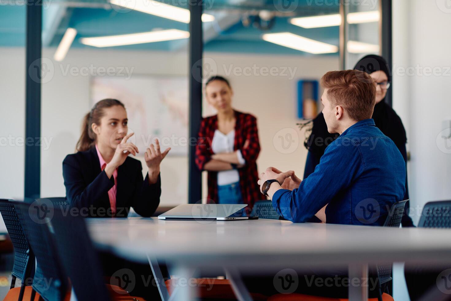 A team of successful programmers sits in a startup office, strategizing new business projects and solving existing challenges, showcasing innovation and collaboration in the tech industry photo