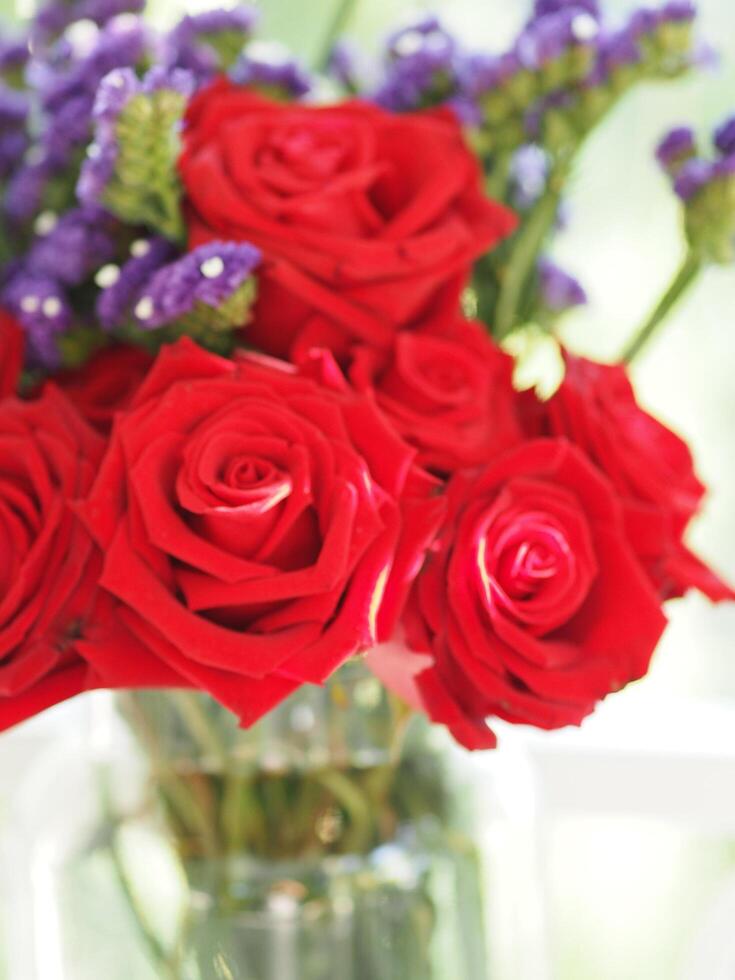 Red rose and Dried statice flower soft pink, violet color in clear glass vase vintage style, Concept for write text design in front background photo