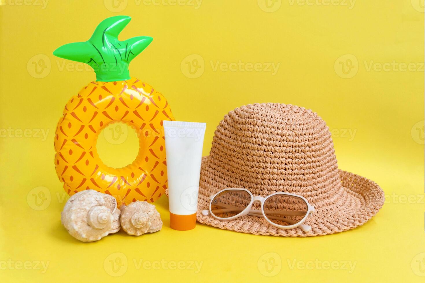sunglasses , striped retro hat and swimming circle on yellow background. summer vacation concept. photo